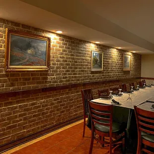 a dining room with brick walls