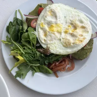 Avocado toast with over hard eggs