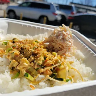 a container of rice and vegetables