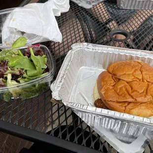Breakfast sandwich with sausage and side salad