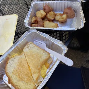 Breakfast sandwich (only egg and cheese) with potatoes