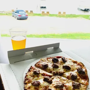 a pizza and a glass of beer