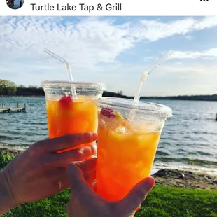 two people holding drinks