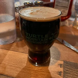 The Com-Bloc black Baltic stout in 12 ounce glass.