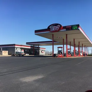 a gas station with cars parked in front of it