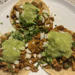 al pastor with onions, cilantro, avocado salsa on the delicious corn tortillas