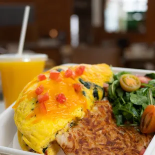an omelet with spinach and tomatoes