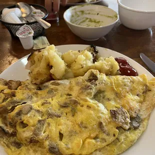 Delicious omelette with buttery home fries.