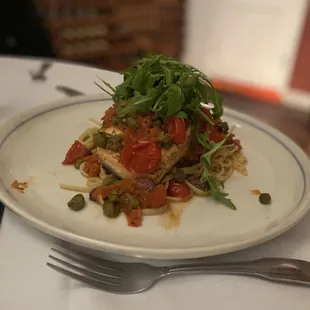 a plate of food with a fork and glass of water