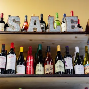 a shelf of wine bottles