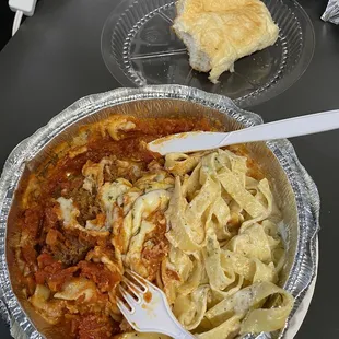 a plate of pasta and a slice of bread