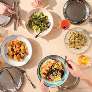a table with plates of food and utensils
