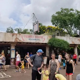 a crowd of people walking in front of a building