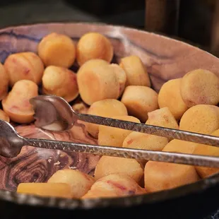a bowl of potatoes and a spoon