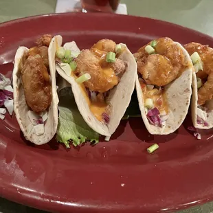 three tacos on a red plate