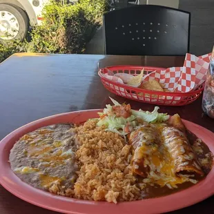 Y Mas Enchiladas plate - comes with 2 enchiladas, beans, rice, salad. And complementary chips and salsa.