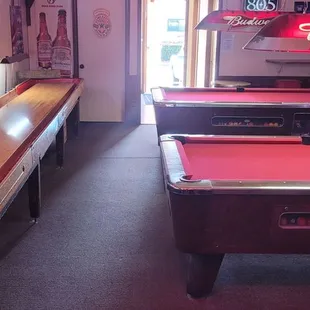 a row of pool tables in a pub
