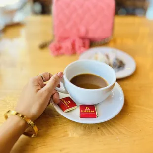 a person holding a cup of coffee