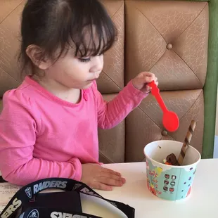 my daughter enjoying the yogurt