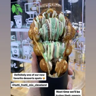 a hand holding a cup of ice cream