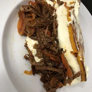 Sweet corn bread with cheese and shredded meat/ cachapa con carne mechada