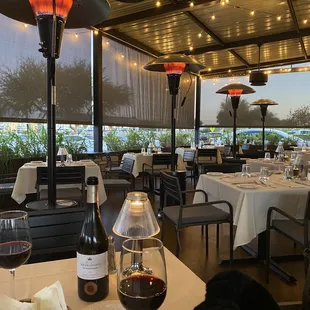 a table with a glass of wine and a bottle of wine