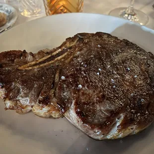 a steak on a white plate