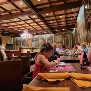 a woman sitting at a table in a restaurant