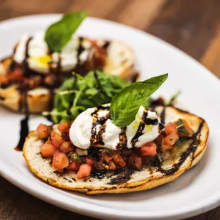 Bruschetta Burratina-Toasted bread, tomatoes and burrata in a balsamic vinaigrette reduction