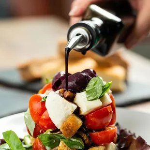 Focaccia Salad- Seasoned garlic-focaccia croutons, fresh mozzarella, tomatoes, roasted almonds &amp; black olives w/Italian dressing