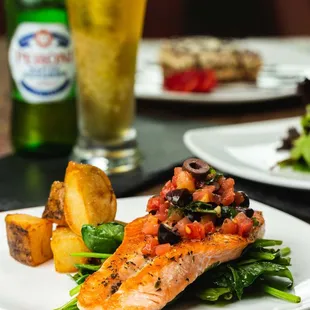 Salmon fillet dressed in a passion fruit sauce served w/ asparagus and roasted potatoes