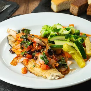 Pan-fried Tilapia filet topped with sautéed garlic, tomatoes, and spinach with a side of seasonal vegetables Special