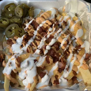 Papas with bacon, nacho cheese, chipotle mayo, sour cream and jalapeños