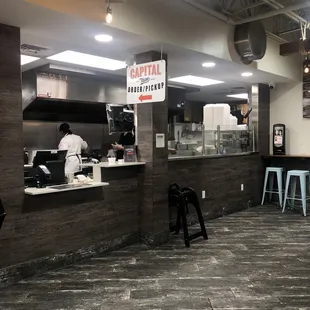 a restaurant counter with a sign that says,