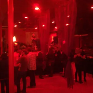 a group of people standing in a dimly lit room