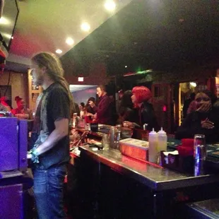 a woman standing at a bar