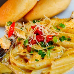 a plate of pasta with chicken and vegetables
