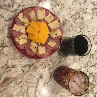 Some slices of salami, sharp cheddar cheese, a glass of wine and a cocktail for my snack and night cap.