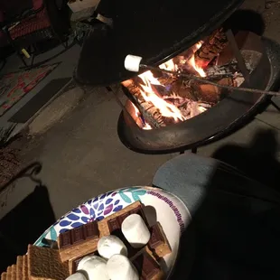 S&apos;mores being made with the fire pit in the backyard.
