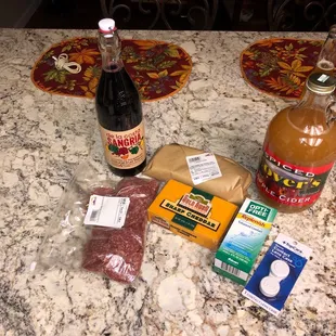 Sangria,  cider, Ribeye Steak, Saline solution, contact lenses case, sharp cheddar cheese and sliced salami.
