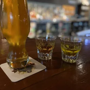 two glasses of beer on a bar