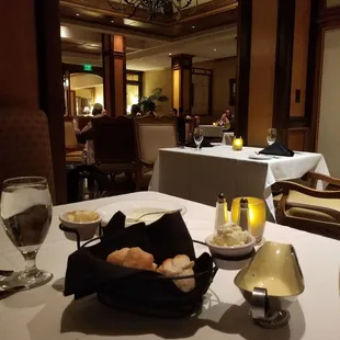 a table setting with bread and wine