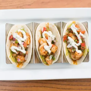 Three soft tacos with guacamole, fresh pico de gallo and sour cream