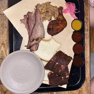a tray of meat and sides
