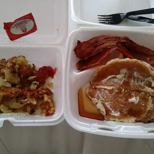 a breakfast of pancakes, bacon and hash browns