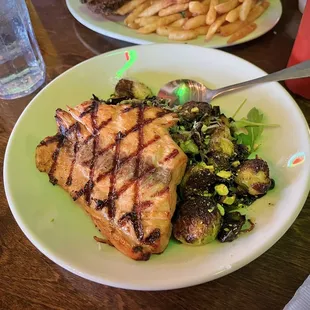 You can request a salmon add-on to the Brussels w. harissa goat cheese appetizer!