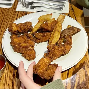 Chicken Fingers and potato wedges.