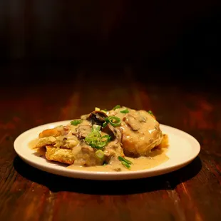 Rich buttery biscuits smothered in creamy mushroom gravy topped with fresh green onions.