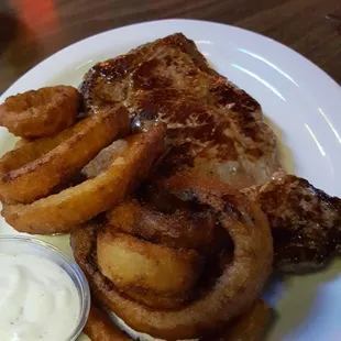 KC strip steak with onion rings.  Dive bar onion rings pair well with ranch dressing.