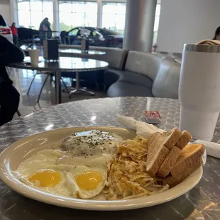 Chicken fried steak, eggs and hash browns.